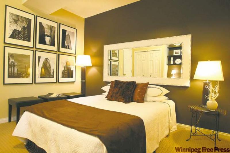 AFTER: Maureen Wright and Johanne Lewis took a $1,000 budget and transformed the drab bedroom into a warm, cosy space complete with artwork. Left: In the finished room, the crisp shades of white featured in the bedding and on the wall mirror work as a striking accent against the warm, chocolate brown accent wall. 