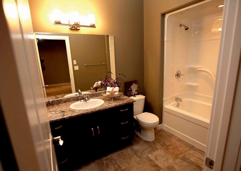 The ensuite contains a soaker tub and maple vanity.