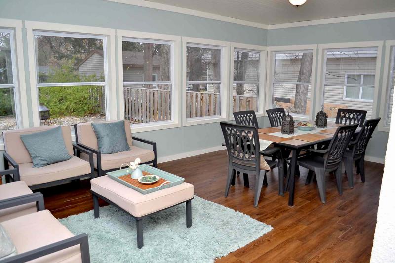 Three season sitting room with dining table.