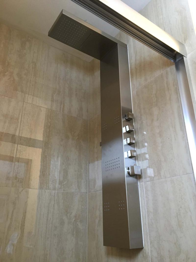 <p>MARC LABOSSIERE</p><p>In lieu of a standard shower faucet pre-plumbed within the wall, water feeds were rough-plumbed and accessed via a small opening behind the intended wall-mount shower column location, easily connected to the column using brass fittings.</p></p>