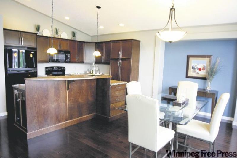 Dark wood cabinets and thoughtful paint schemes highlight the possibilities of the show home at 15 Terry Fox Drive.
