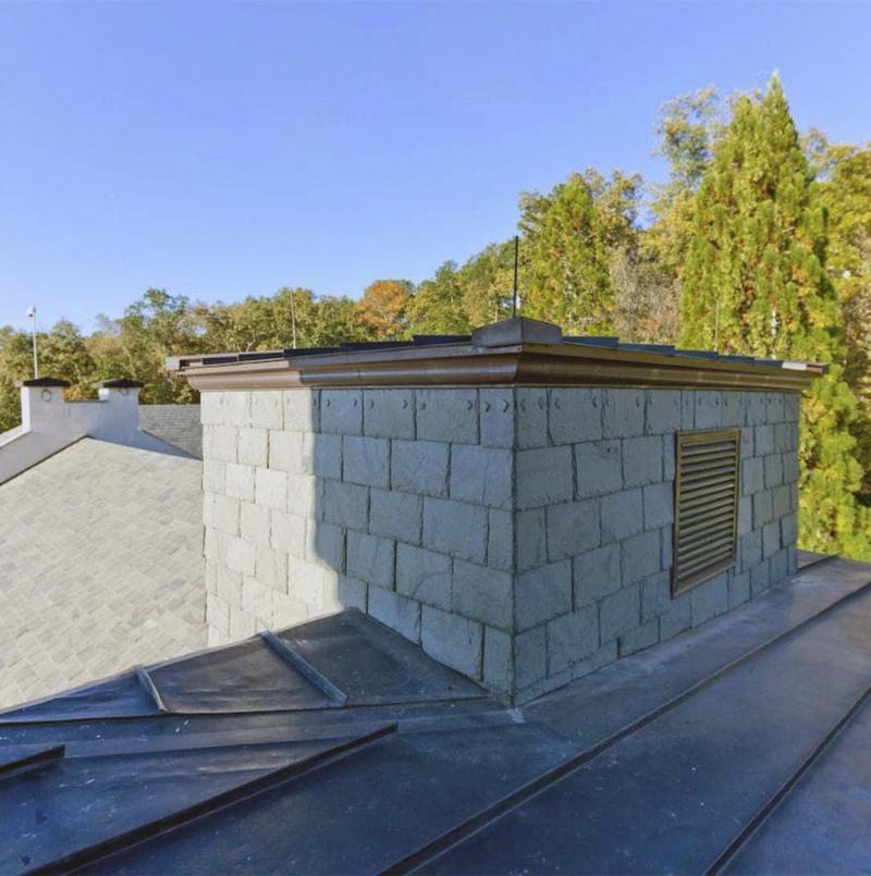 <p>Courtesy of Paul Wegener / Atlanta Fine Homes Sotheby&rsquo;s International Realty</p><p>The observation tower comes with a glass floor and hidden spiral staircase so residents can make a quick getaway. This view toward the rear of the home shows the different types of roofing materials used. </p></p>