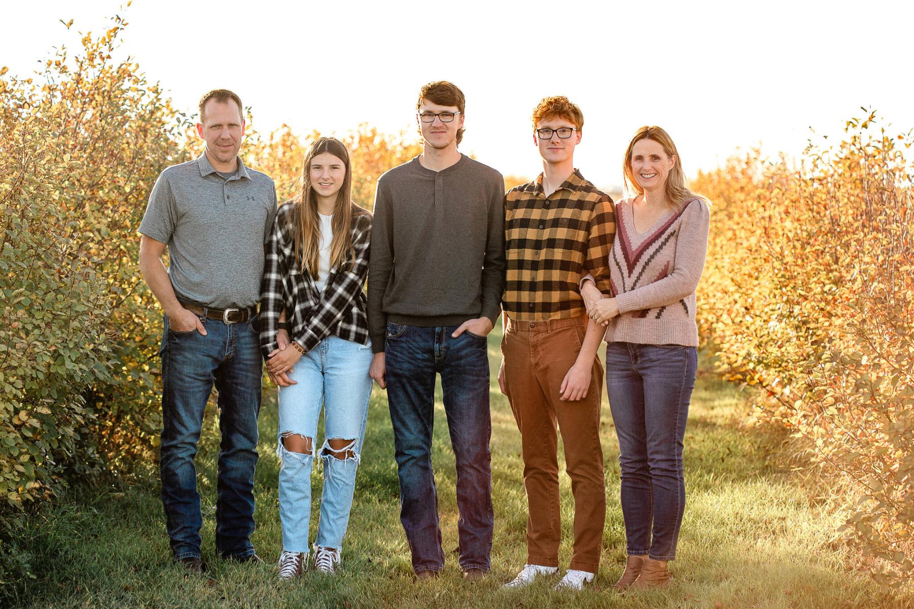  <p>The Purple Berry Orchard</p>
                                <p>Brent Wolfe (far left) and Sheila Wolfe (far right) in their orchard with their children in the fall.</p> 