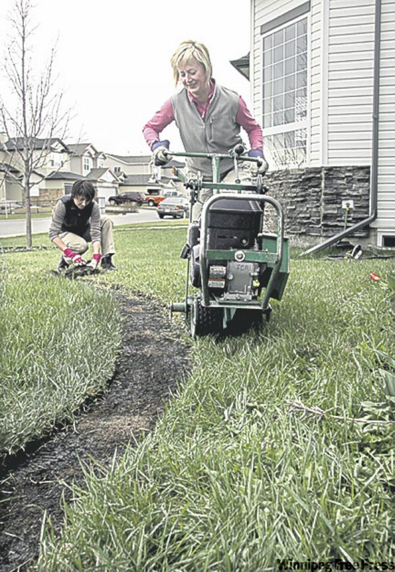 Yvonne Jeffery, right, tussled with an 80-kilogram sod cutter to clear her yard for her makeover.

