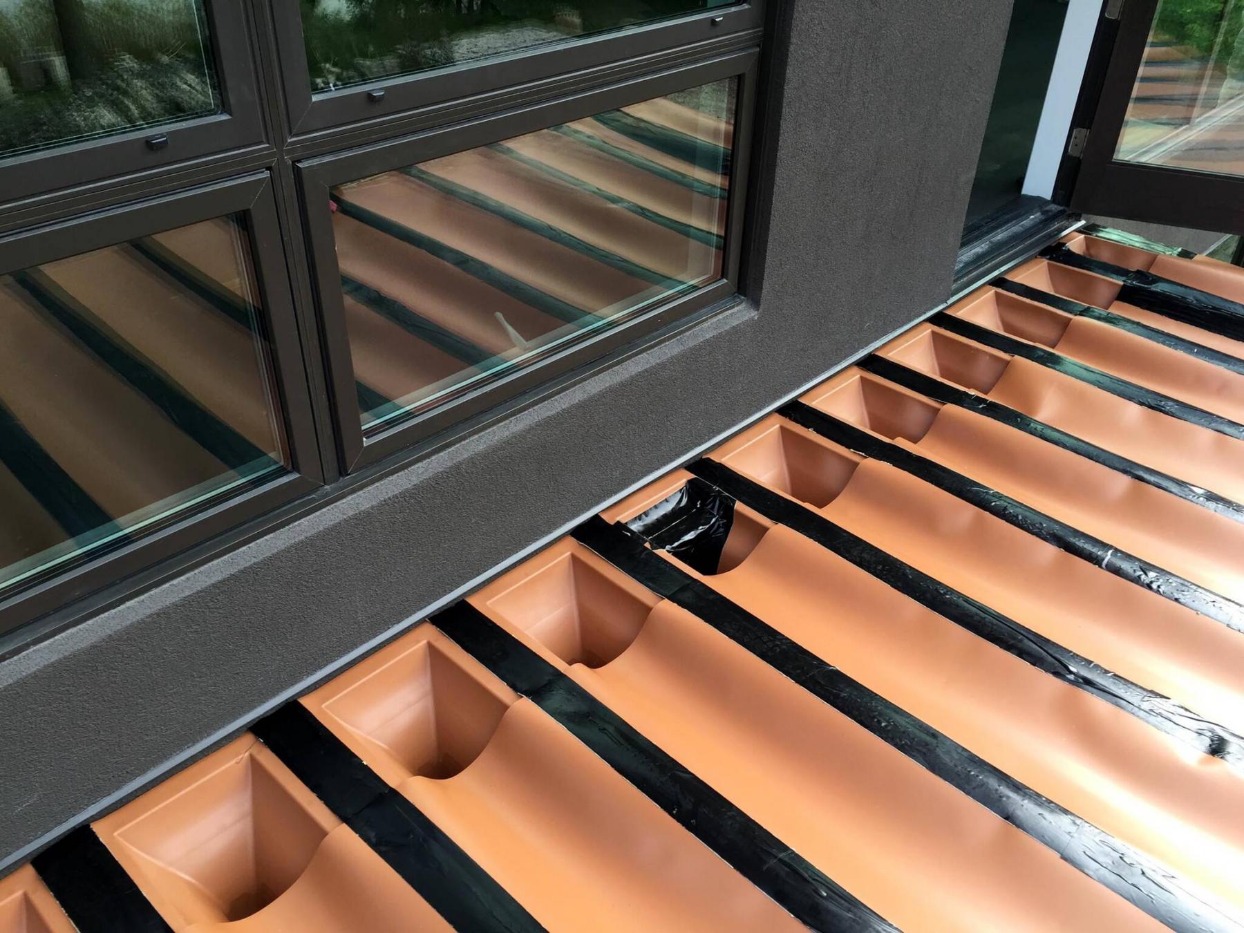 <p>Photos by Marc LaBossiere / Winnipeg Free Press The RainEscape membrane is placed atop the gaps of every joist of the balcony creating a slight grade directing water towards the downspouts.</p>