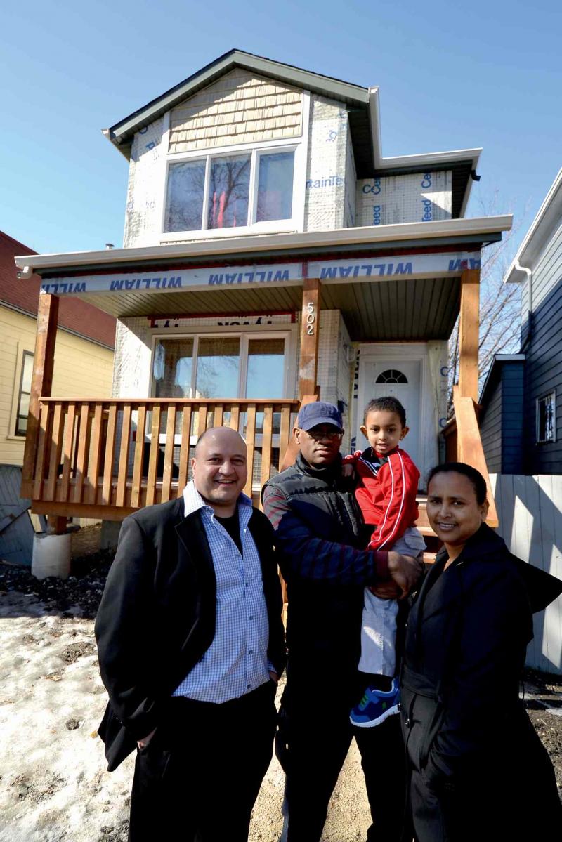 Realtor Frank Zappia (left) with the latest family to access an affordable new home in the city's West End thanks to the efforts of Housing Opportunity Partnership (HOP).