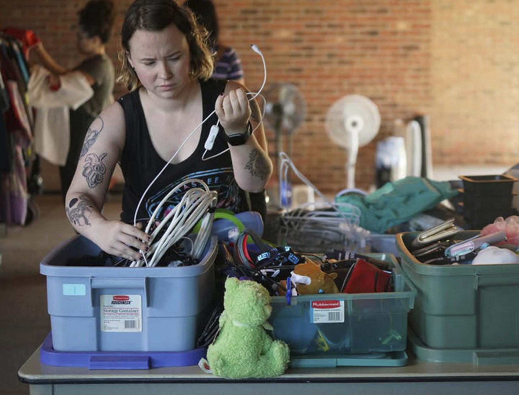 <p>Hamline University senior Anissa Mench rifled through cords and cables during the school's "free store" event outside Bush Memorial Library. (Shari L. Gross/Minneapolis Star Tribune/TNS)</p>