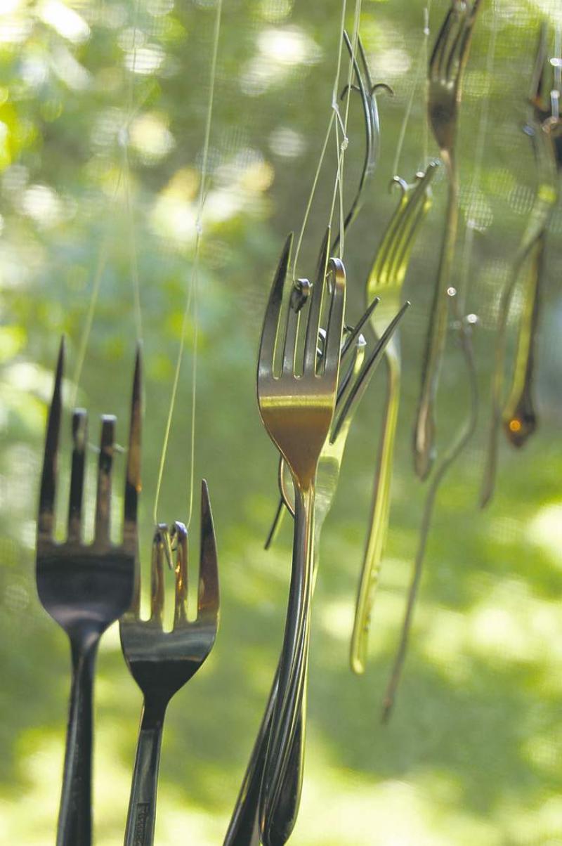 Consider making a decorative wind chime from old forks. Bend the tines on each fork so you can run some fishing line or strong twine through them and hang them from a bar, a dowel or what have you to create a soft chime in the yard or inside the home near an open window.