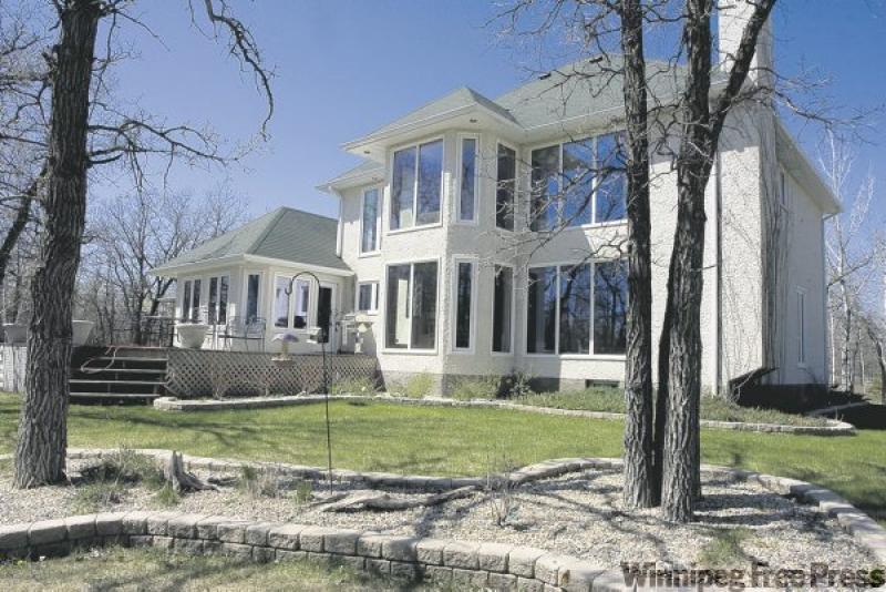 40 Oak Park Lane near Stonewall features a back wall filled with glass to take in the view of its large backyard.