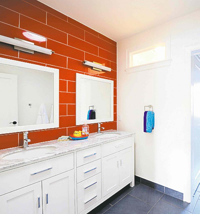 With the injection of red tiles in this children's bathroom, left, not only is a playful mood created but the vanity area becomes the focal point.