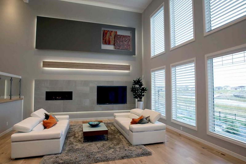 The family room has soaring ceilings, six floor-to-ceiling windows and tile entertainment unit (with ribbon-style fireplace and niche for 70-inch flat panel TV.)