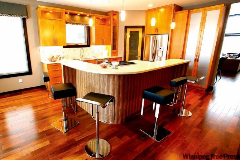 The kitchen is built around a huge island, has a built-in natural gas cooktop and grill, and includes plenty of counter and cabinet space.