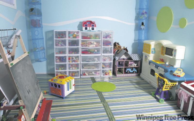Deveau (with daughters) made a playroom from her husband's gym.
