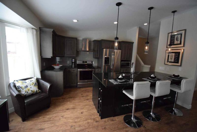 A large island provides separation between the kitchen and dining area.