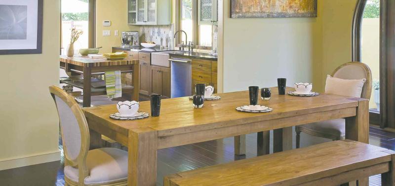 This lovely kitchen and dining room offer a good example of how to make the transition between rooms with style.
