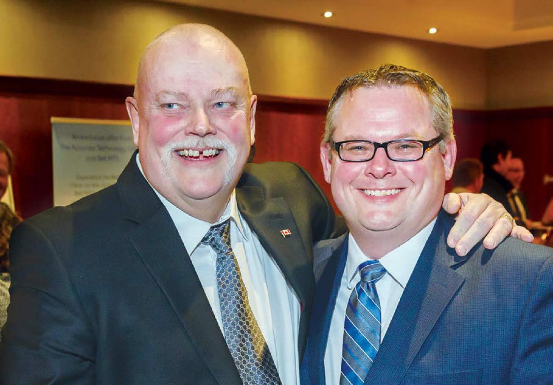 DEREK THORSTEINSON (LEFT) WITH MHBA PRESIDENT AND CEO LANNY MCINNES, HOLDS HIS HONORARY LIFE MEMBERSHIP CERTIFICATE.