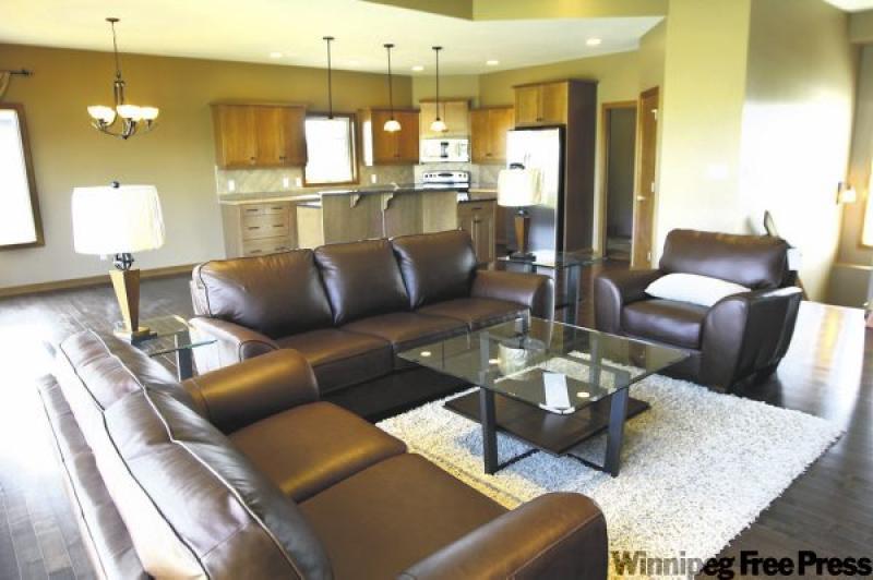 Bill McGarry, sales representative for Irwin Homes, below, says the home has features that make it feel larger than its 1,625 square feet, including a tray ceiling in the great room.

