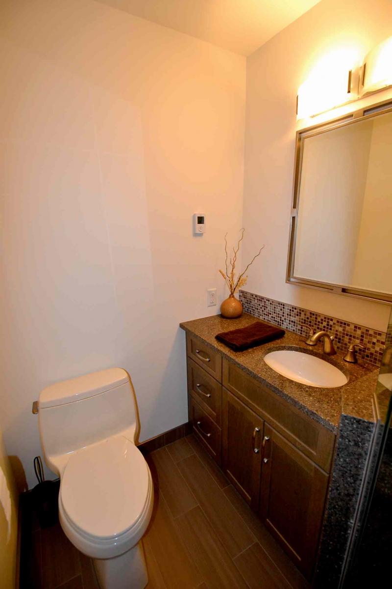 Placing the shower and vanity to the right and toilet to the left brought new flow and style to the compact ensuite.