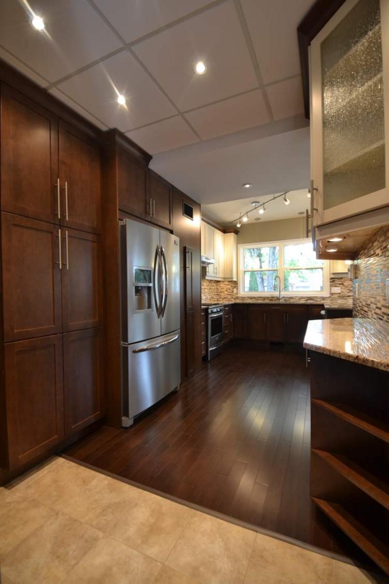 Kitchen's rear portion offers additional storage and function via a huge pantry, extra shelving and Euro-style cupboards.