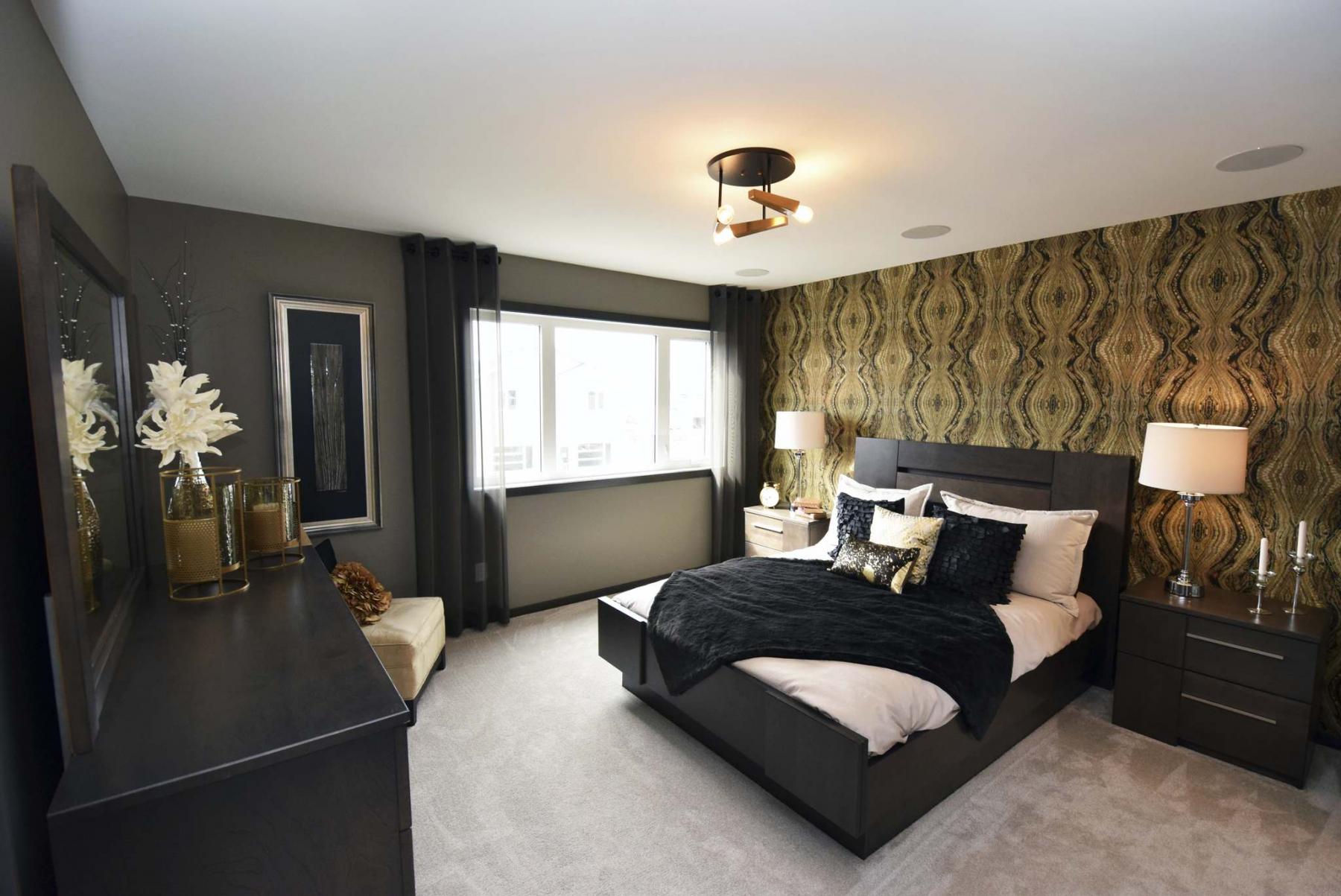 <p>A textured wallpaper feature wall gives the spacious master suite a warm, welcoming feel.</p>