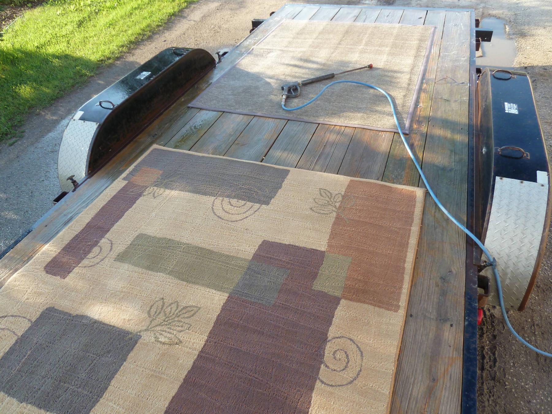 <p>Photos by Laurie Mustard / Winnipeg Free Press</p><p>A car trailer turned out to be the perfect platform to clean these area rugs with a pressure washer.</p>