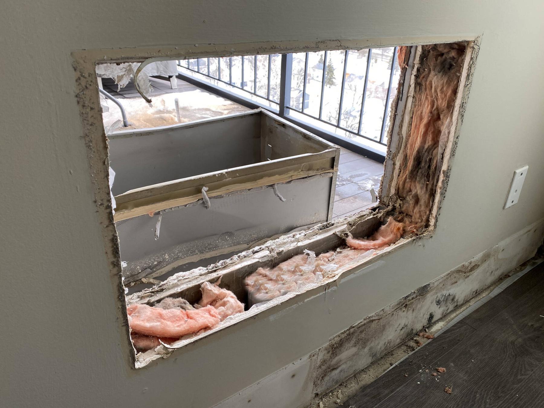  <p>Once the unit and the sleeve was removed, the void in the wall was framed, insulated, and made weather-resistant.</p> 