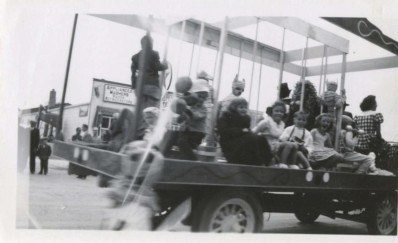 <p></p><p>In this shot, you can see my sister Bonnie (centre) wearing a lei and riding a float in the parade.</p>
