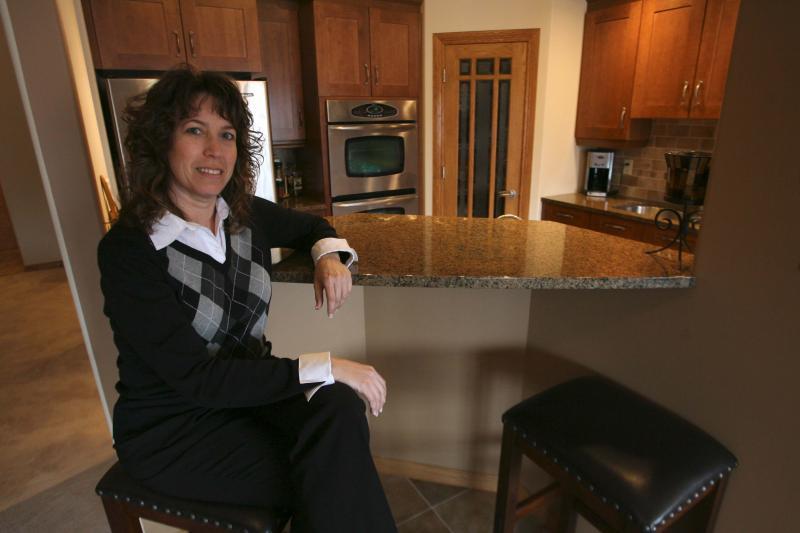 Realtor iRonda Erenberg of Royal LePage Dynamic in kitchen of condo at 403-380 Wellington Crescent. 