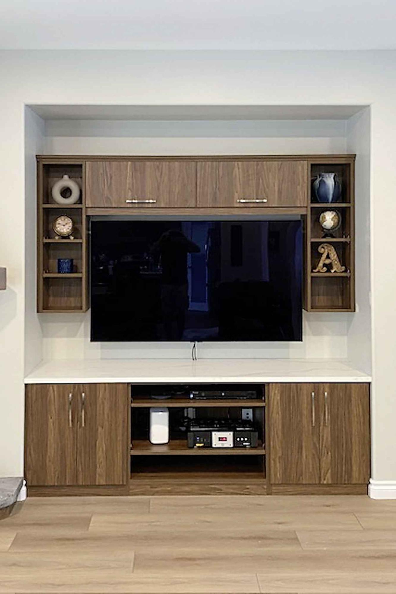  The new TV and entertainment area features custom cabinets with a quartz countertop and a wall-mounted flatscreen TV. (Marc Labossiere / Free Press) 