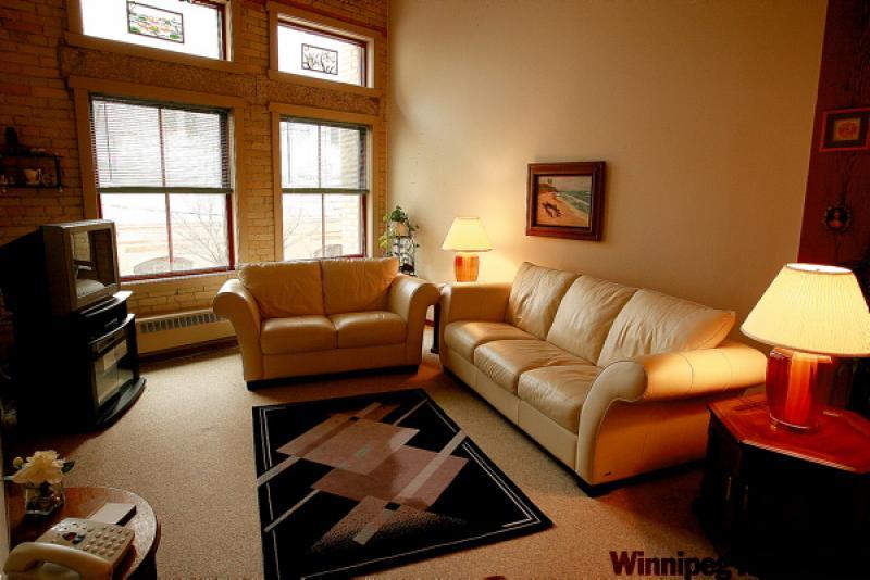 Brick walls, transom windows and exposed wooden beams are all part of the charm, but the unit is thoroughly modern where it counts, such as the bedroom, kitchen and bathroom (below.)