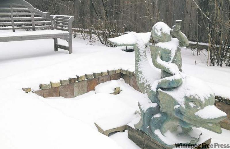 Architectural elements such as this water feature in John Tinkler's Winnipeg garden can be equally stunning in summer or winter.