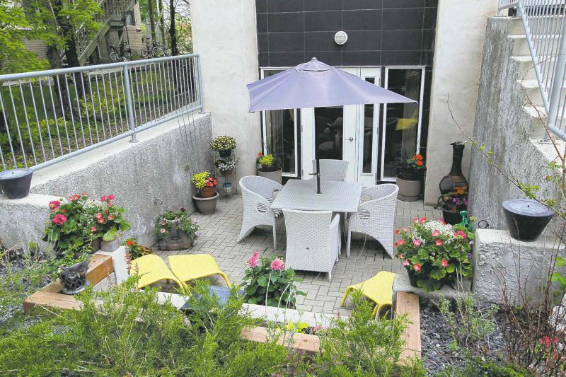 A walk-out lower level off the media area features a private, sunken patio.
