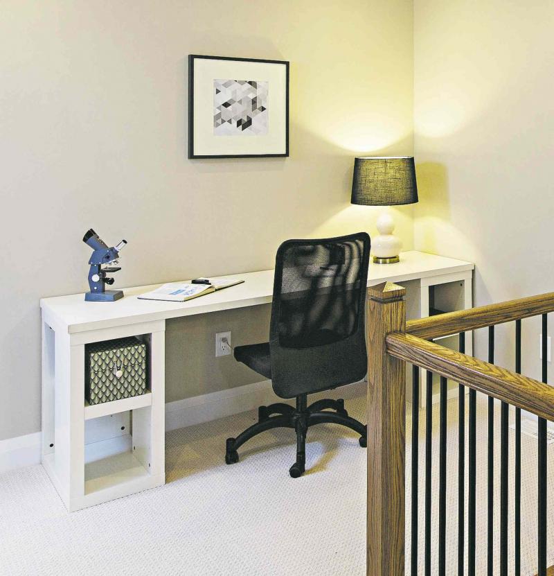 This narrow desk transforms a second-floor landing into a functional and stylish home office.