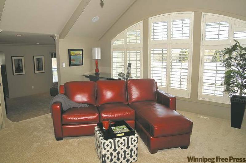 Floating the furniture in this seating area off the master bedroom works well with a wall of windows, thus maximizing the feeling of spaciousness needed for the success of this room design. 