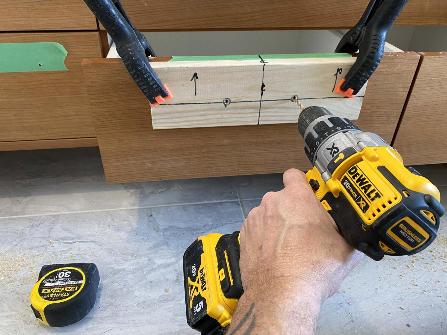 <p>Marc LaBossiere / Winnipeg Free Press</p><p>With the handle-mounting template clamped to the drawer front, holes were confidently drilled. </p>