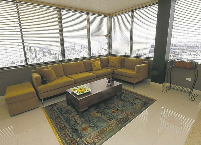 A four-season sunroom offers massive windows with an amazing view.