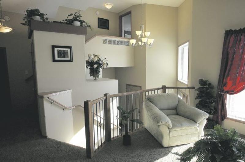 The sunken foyer leads not only from the garage and entrance to both the main and lower levels, it also holds a convenient laundry room. The exterior features a variety of materials for strong visual 