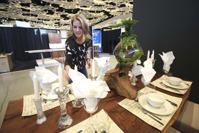 <p>Jessica Botelho-Urbanski / Winnipeg Free Press files</p><p>Kelsey Kosman of Dollhouse Design sets up her booth at the Winnipeg Renovation Show.</p>