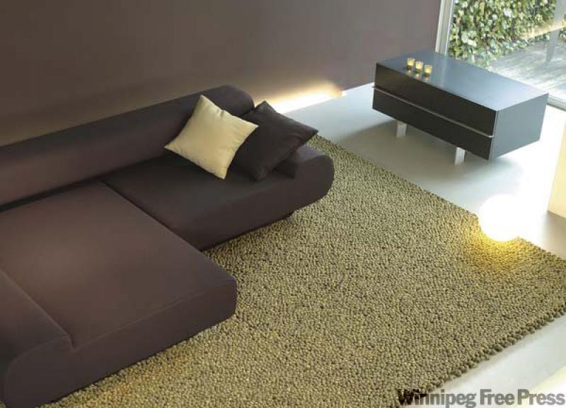 The carpet looks like pebbles but is actually wool. It's produced by Orange Skin.
