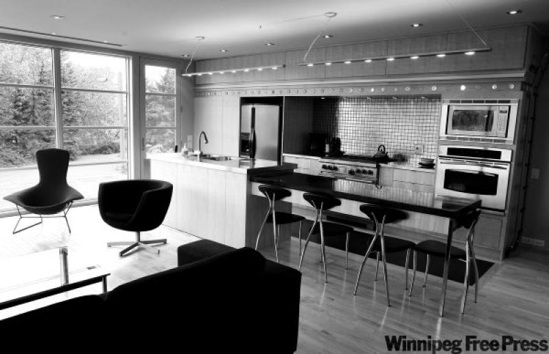 Maple cabinetry and flooring create a calm, light-reflecting backdrop in this dramatic redesign of a 1950s bungalow.
