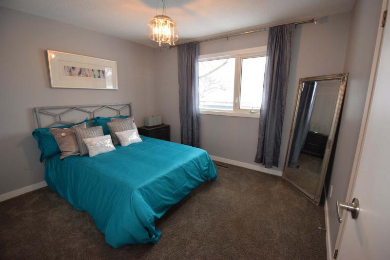 <p>Plush new carpeting and a warm grey colour palette give the master suite a cozy feel, while an oversized window lets in loads of natural light.</p>
