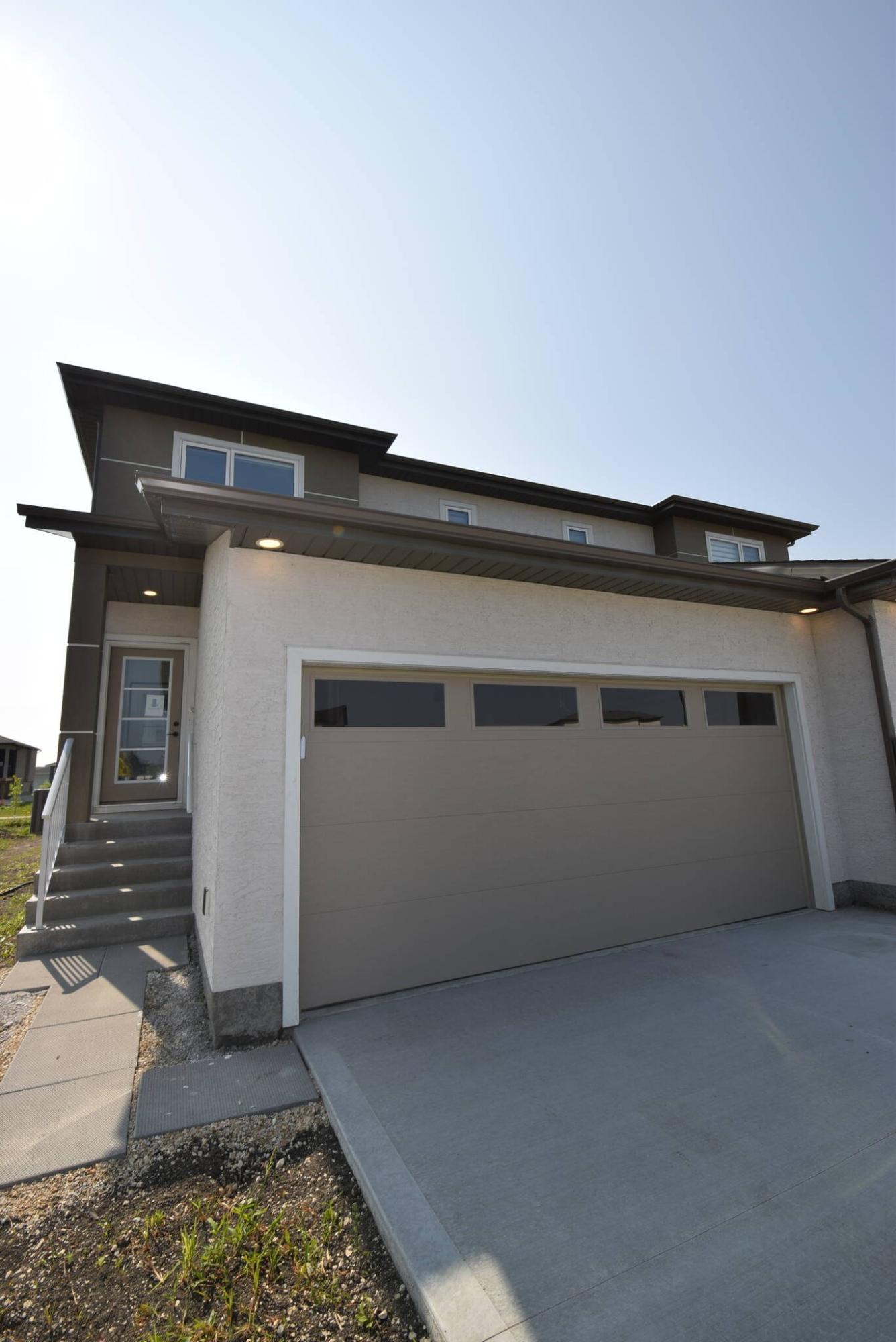  <p>Photos by Todd Lewys / Free Press</p>
                                <p>This two-storey attached home is a value-packed design that is due to be followed up by a series of attached two-storeys just a stone&rsquo;s throw away.</p> 