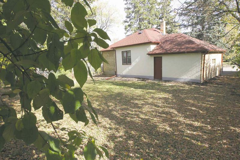 An attached garage backs onto a huge, fenced backyard.