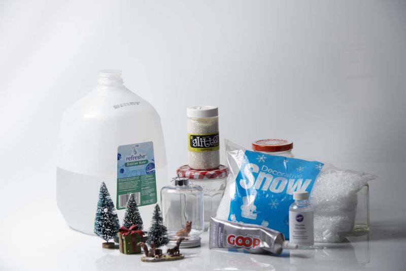 <p>Nikki Kahn / The Washington Post</p><p>Items needed for homemade snow globes include distilled water, ornaments, glitter, empty jars, glue, glycerin and snow flakes. </p>