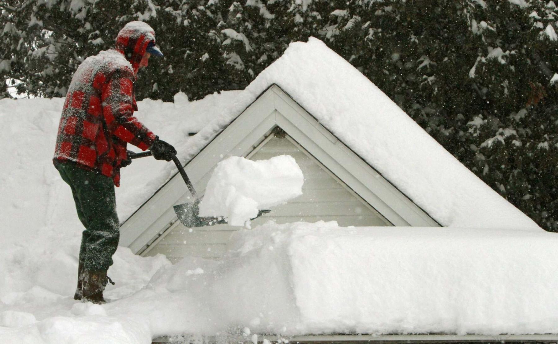 <p>Although experts recommend you hire a professional to clear snow off your roof or clear a clogged vent, Laurie Mustard prefers to live dangerously and do the chores himself. (Toby Talbot / Associated Press files)</p></p>
