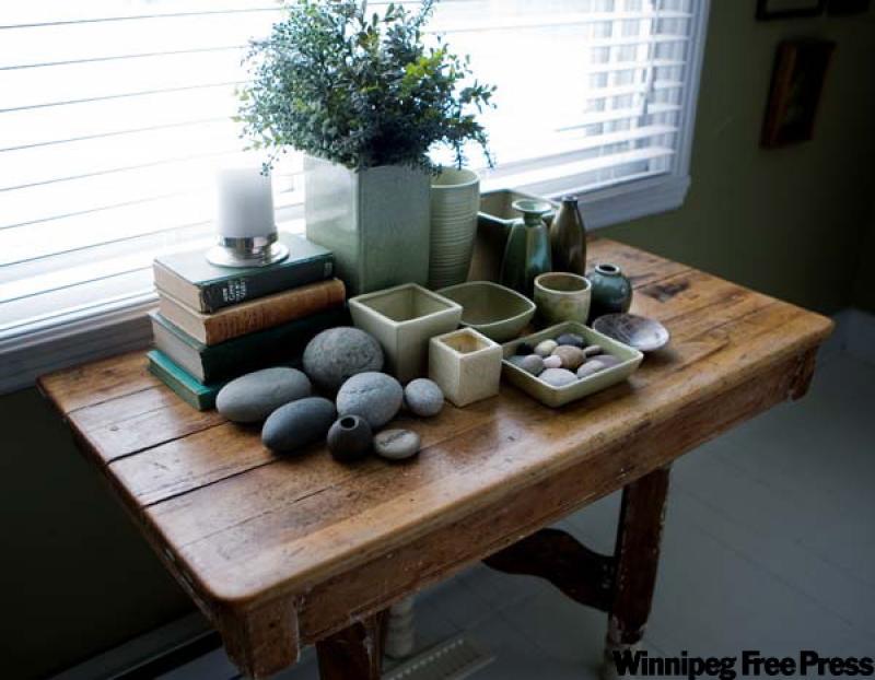 This old semi-refinished pine table holds a display of accumulated mismatched accessories.