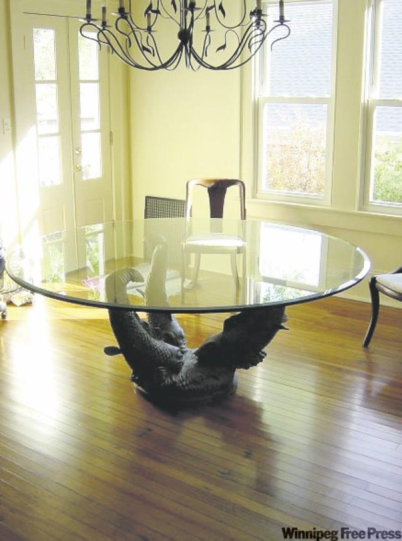 Lost in the devastation  of hurricane Katrina, their original mahogany dining room set, below, exemplified their love for traditional style. Above, this  dramatic, modern dining room celebrates a cour