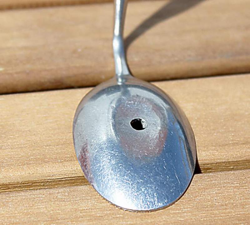STEP 1 (above): Lay the spoon wrong side up on a sturdy surface and hit the scoop with the hammer to flatten its "bubble". Drill a hole in the middle of the spoonâs now flattened scoop. This is where the screw will hold the "hook" to the wall.