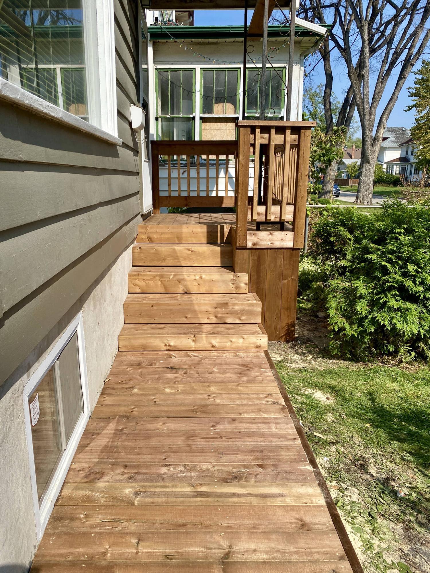  <p>To remedy the awkward slant and twisting of the walkway, lumber joists were ripped and shimmed to create a level platform.</p> 