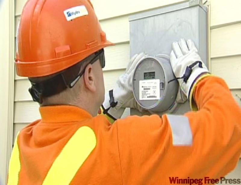 A hydro electrician installing a smart meter. 